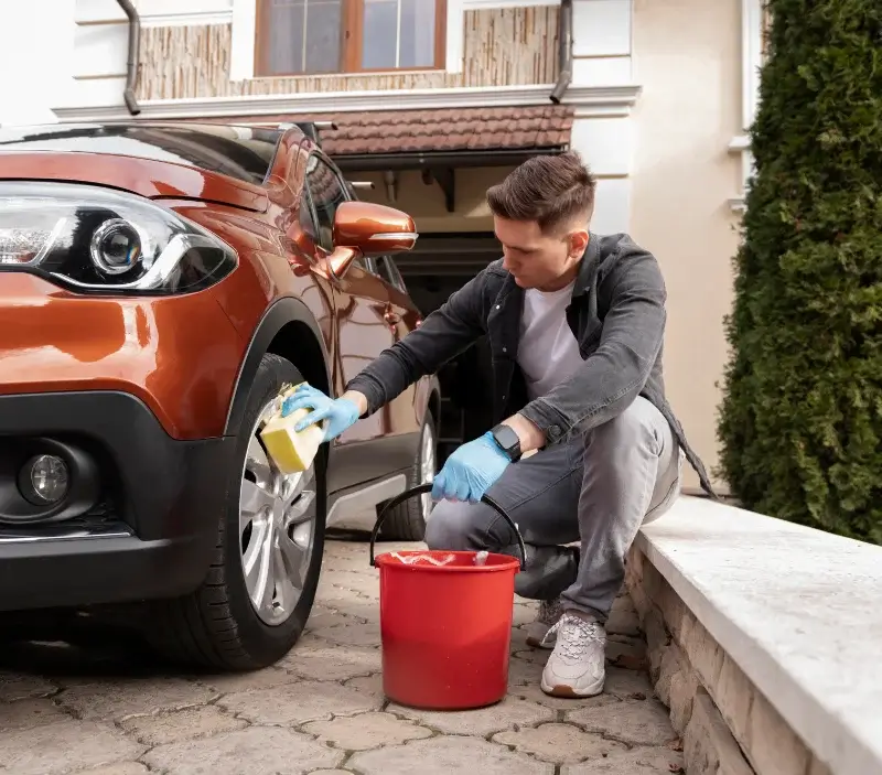 Lavage auto à domicile Chalvignac : professionnel intervenant sur un véhicule